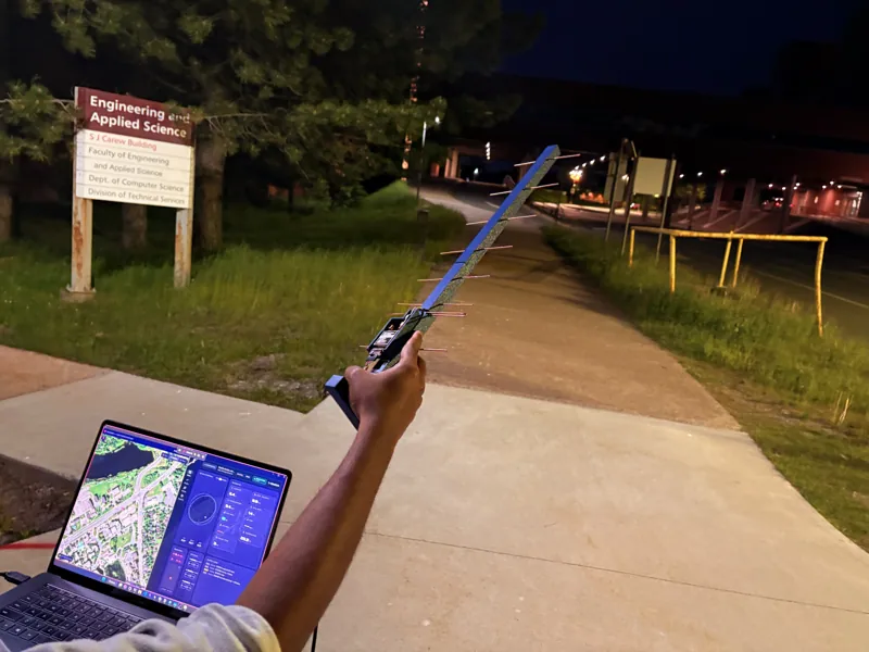 Handheld antenna and ground-station laptop during an outdoor test