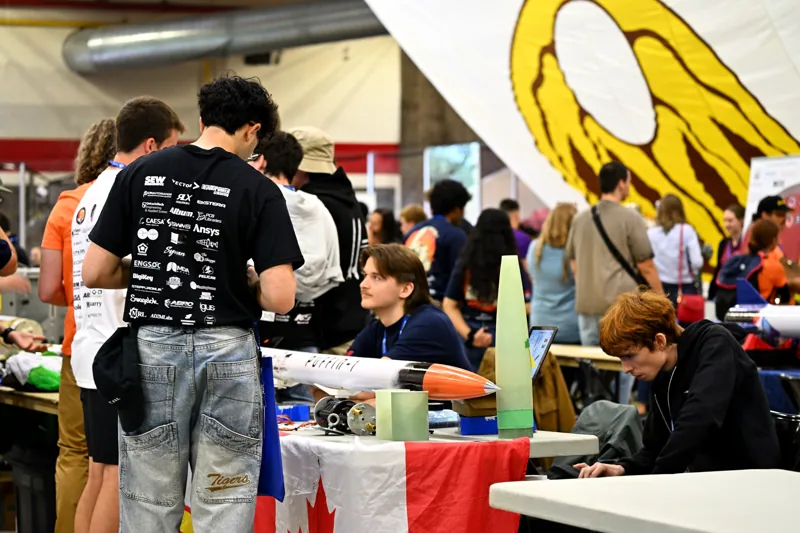 Visitors talking with the team at the exhibition table
