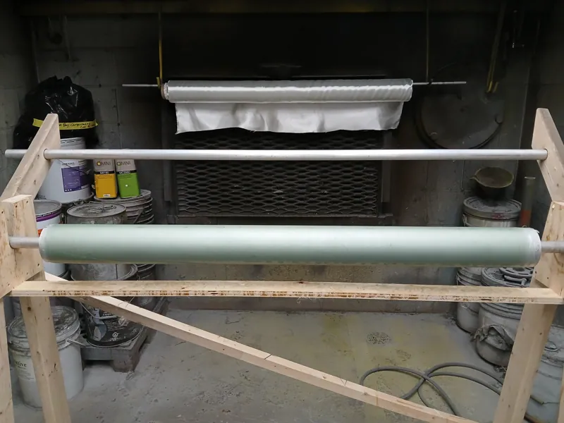 Fibreglass tube supported on a workshop fixture